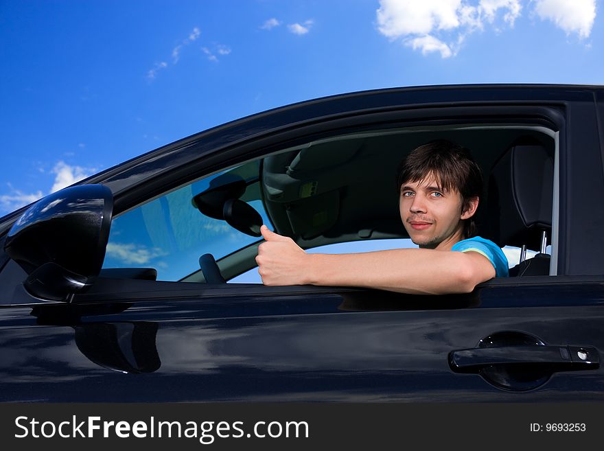 Successful young man sitting in own car