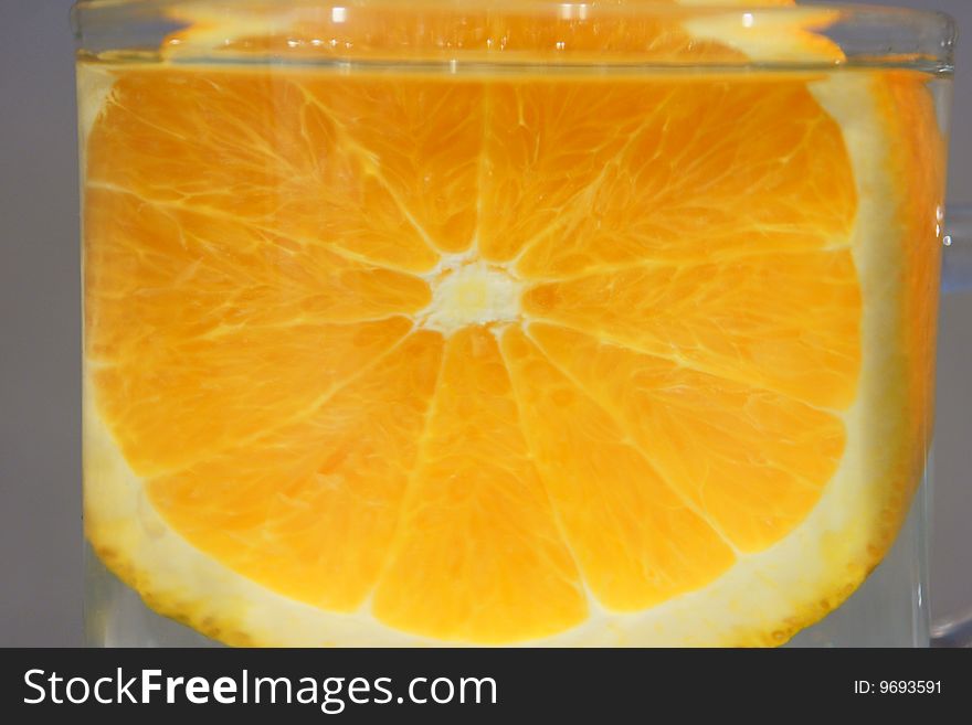Orange fruit in glass on water