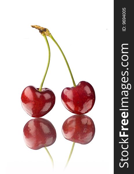 A pair of cherry on a mirror with white background