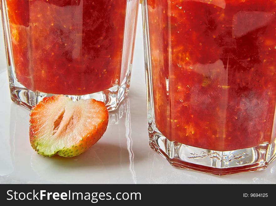 Glass of Strawberry Jam and sliced Fruit