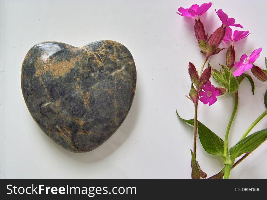 Heart made out of Stone with pink Flower. Heart made out of Stone with pink Flower
