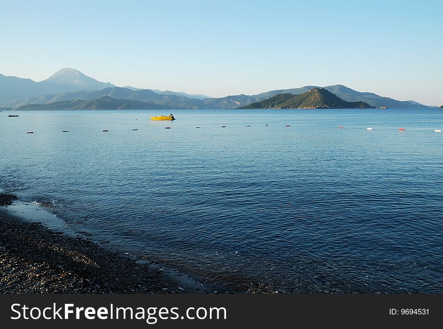 Coastline of a bay with mountains on a horizon. Coastline of a bay with mountains on a horizon