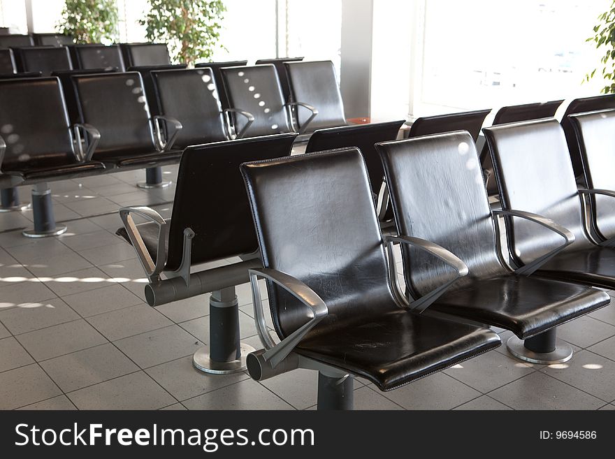 Some leather chairs at an airport gate. Some leather chairs at an airport gate