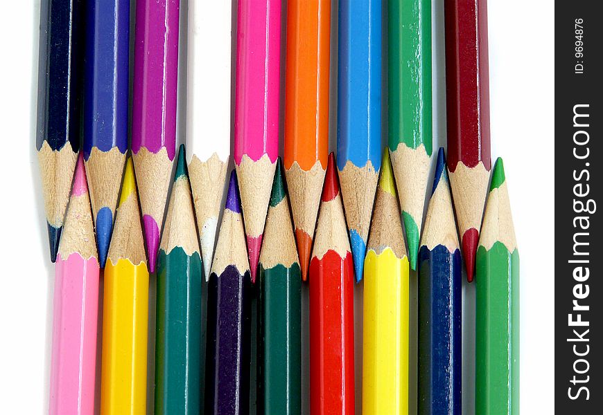 Two rows of multicolored pencils, isolated over white