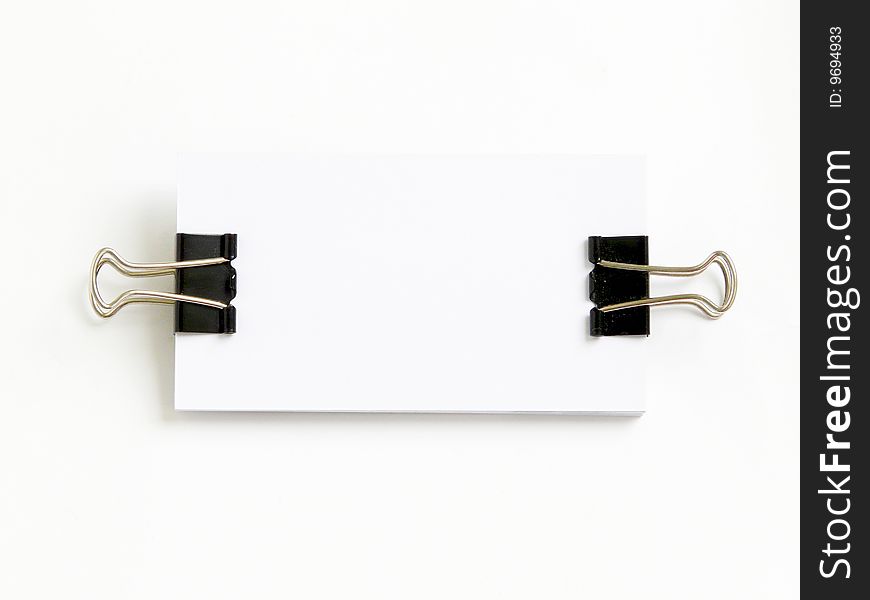 Block of white cards attached with paperclips, isolated over white