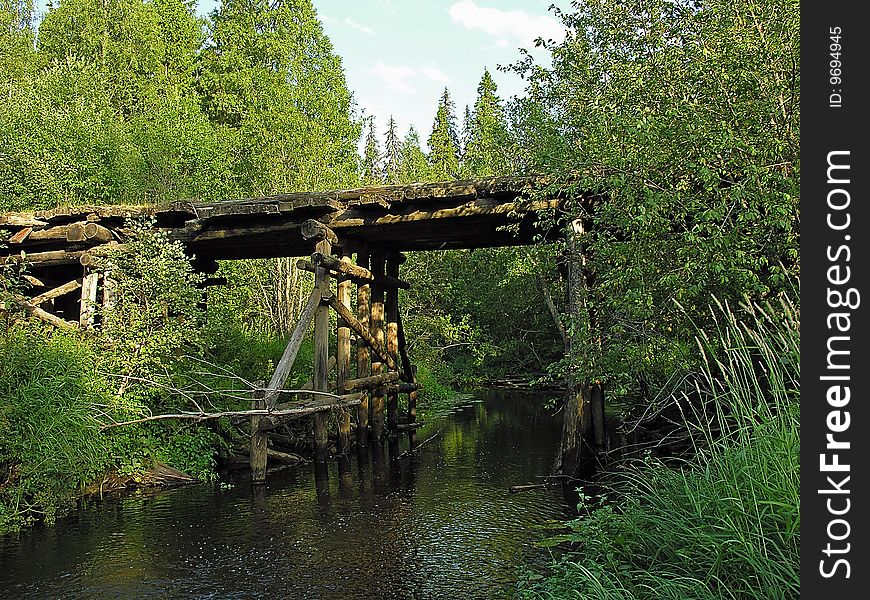 Russia, Sougth Karelia, wooden bridge on the road through the forest. Russia, Sougth Karelia, wooden bridge on the road through the forest.