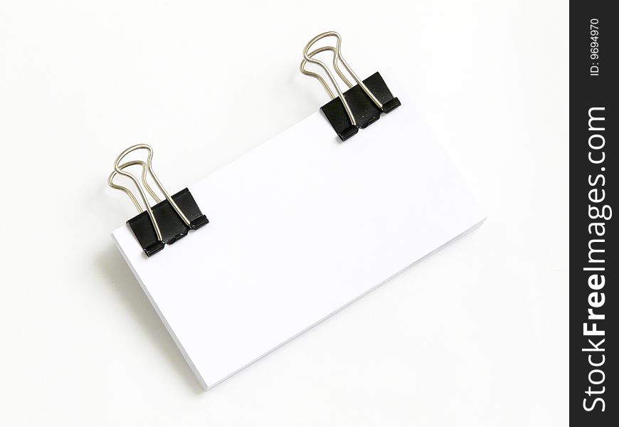Block of white cards attached with paperclips, isolated over white