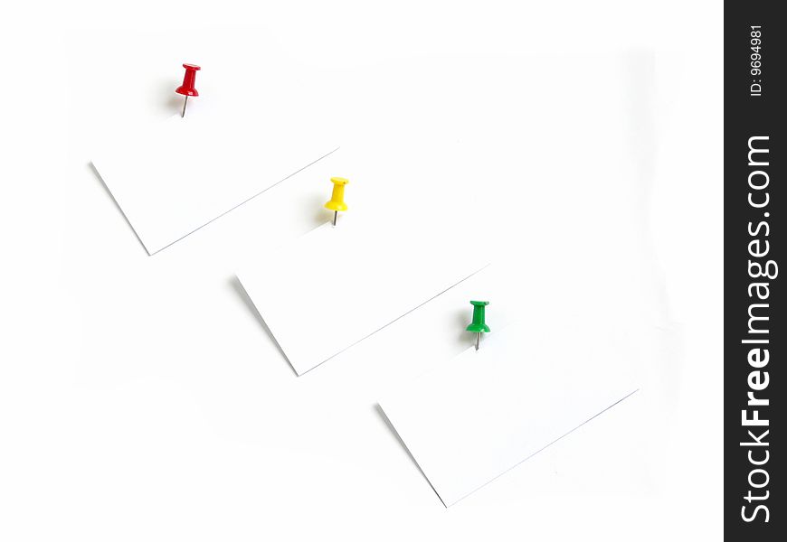 Notes with colored thumbtacks, isolated over white