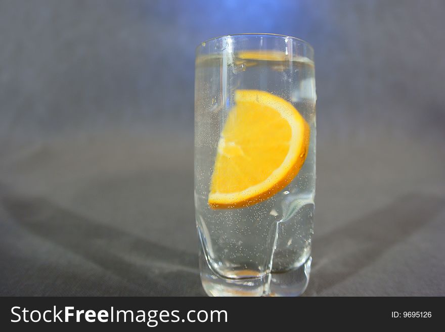 Orange fruit in glass on water