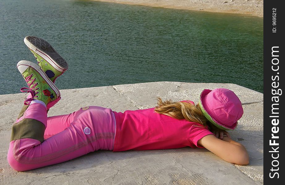 Girl in pink cap vacation on sea port. Girl in pink cap vacation on sea port