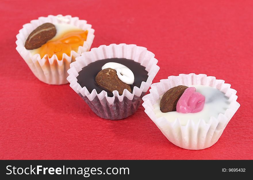 Chocolate candies in the white paper rosettes. Chocolate candies in the white paper rosettes