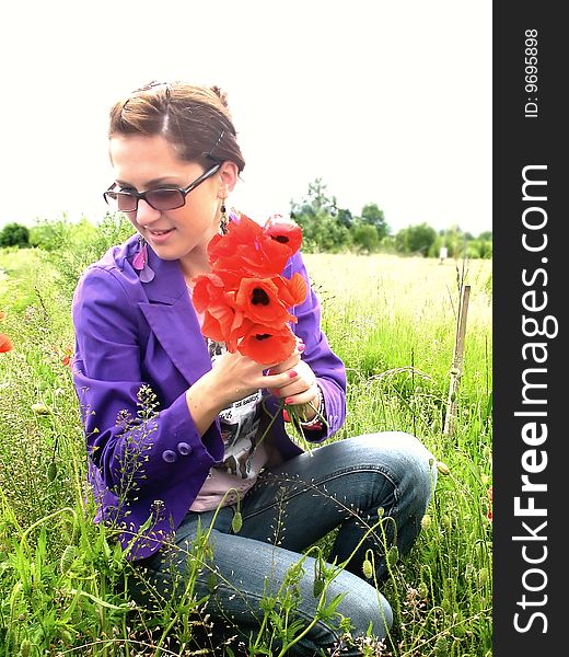 Young girl among red poppies on the meadow. Young girl among red poppies on the meadow