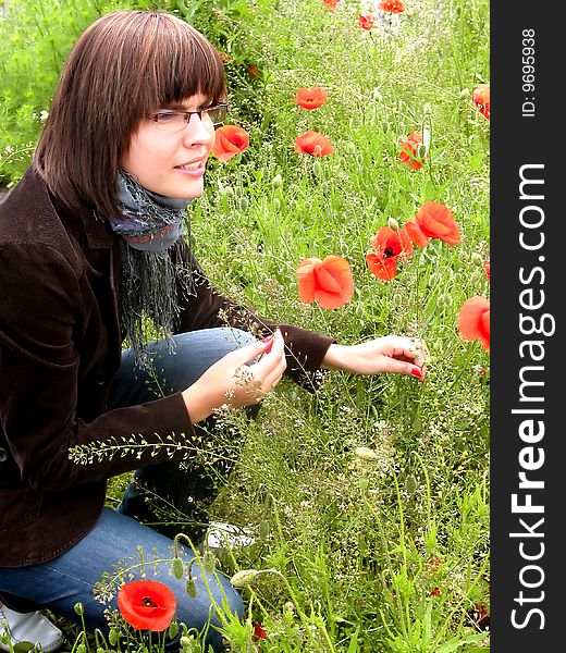 Young girl among red poppies on the meadow. Young girl among red poppies on the meadow