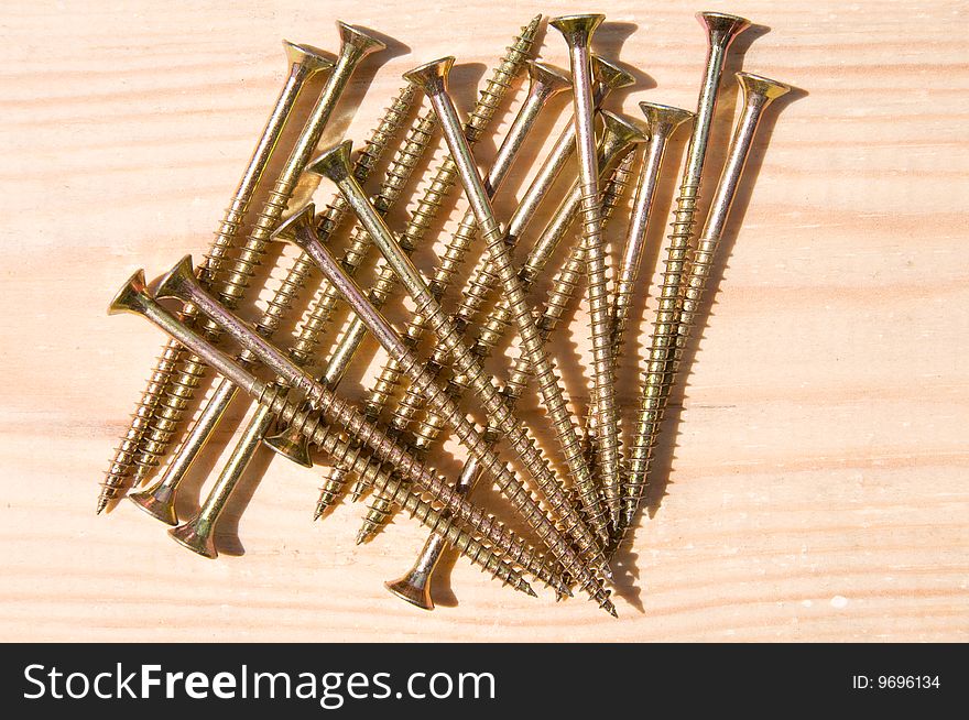 Long screws on a wooden table