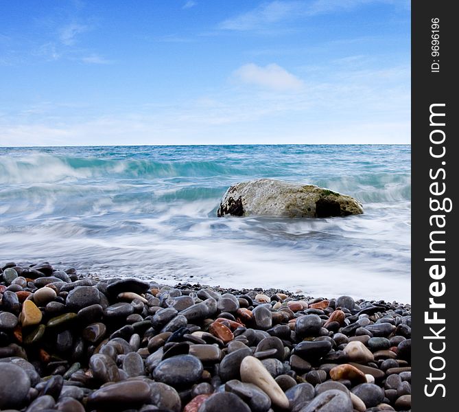 Beach of the sea and blue sky with clouds