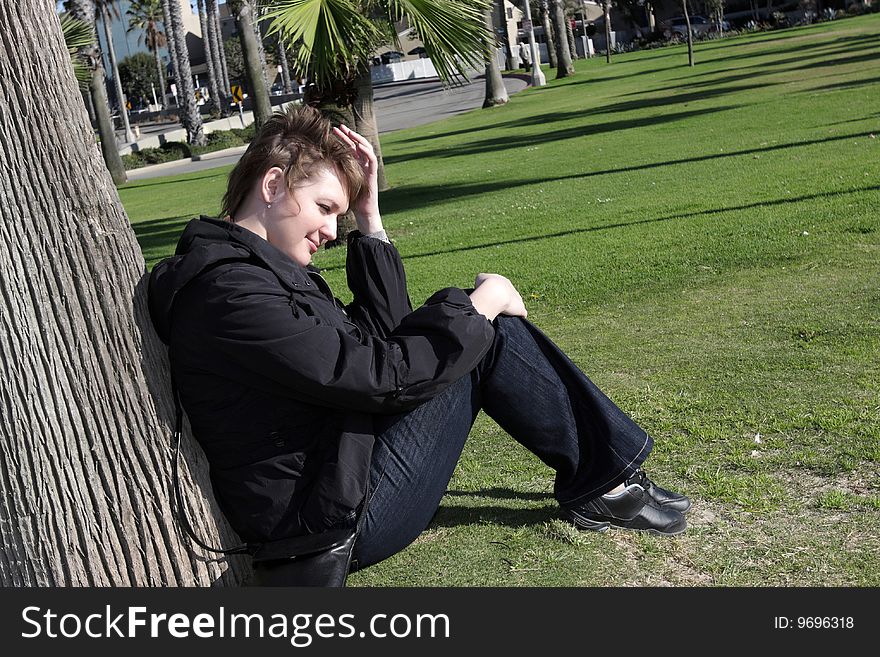 The young woman rests after a long walk. The young woman rests after a long walk