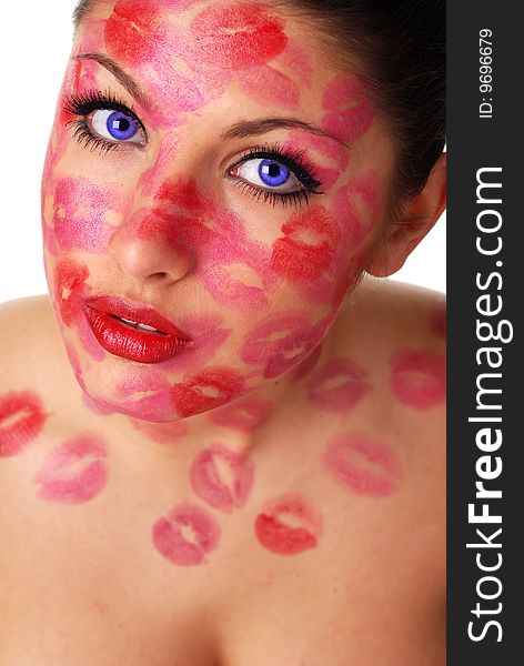 Beautiful woman with stamps of red lipstick on her face