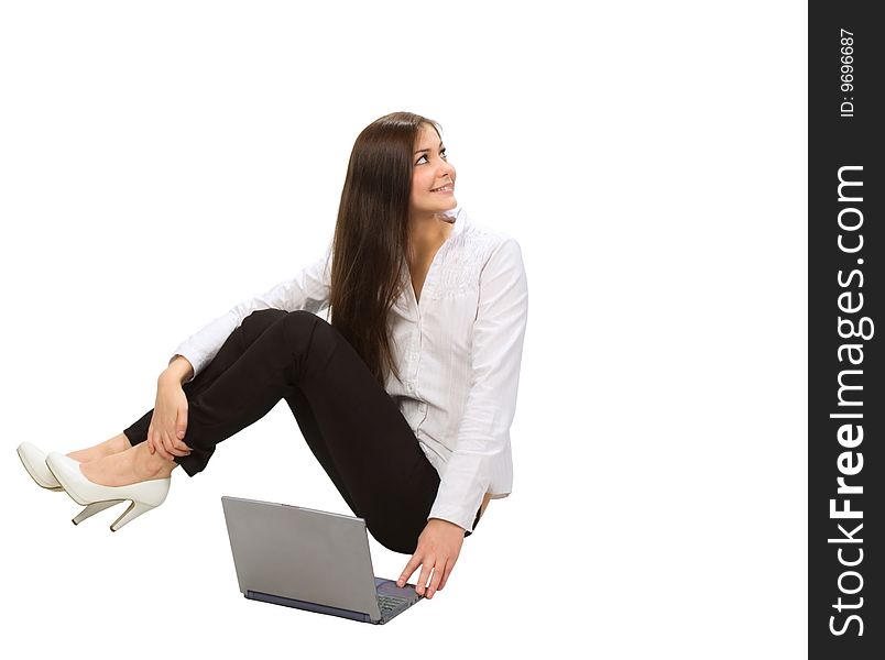 Young businesswoman with laptop sitting on floor
