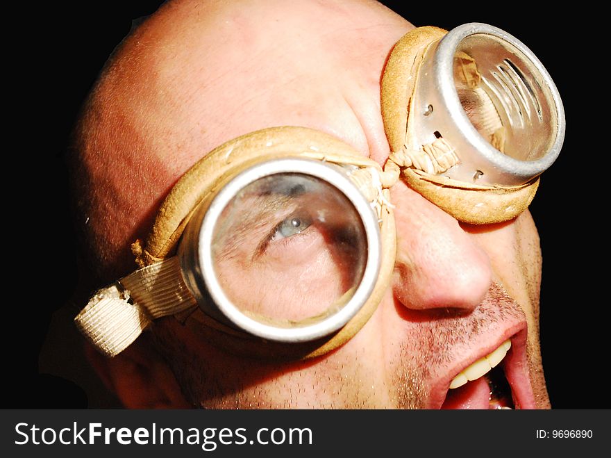 Man in welding goggles on the black background. Man in welding goggles on the black background