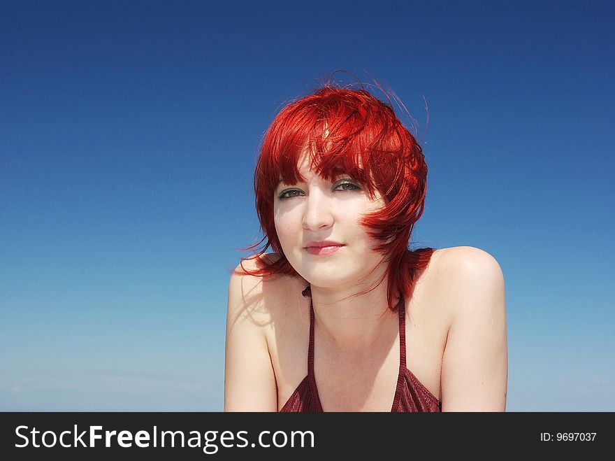 Red-haired girl at the beach on sunny day. Red-haired girl at the beach on sunny day