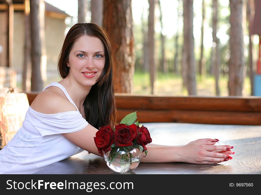 Beautiful girl with roses on a terrace. Beautiful girl with roses on a terrace