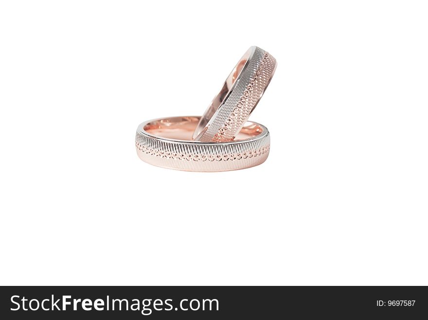 Two shiny golden wedding rings isolated over white background