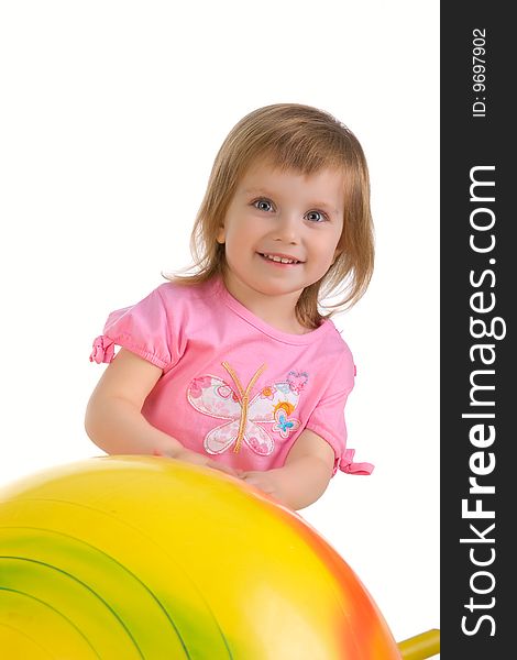 Little girl and big yellow ball on white background