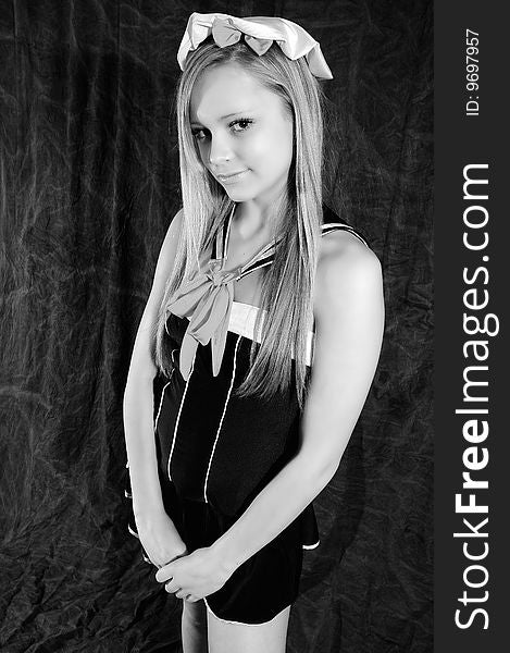 Young female fashion model looking innocently at the camera wearing a sailor outfit altered to black and white to show the clear complexion of her skin. Young female fashion model looking innocently at the camera wearing a sailor outfit altered to black and white to show the clear complexion of her skin.