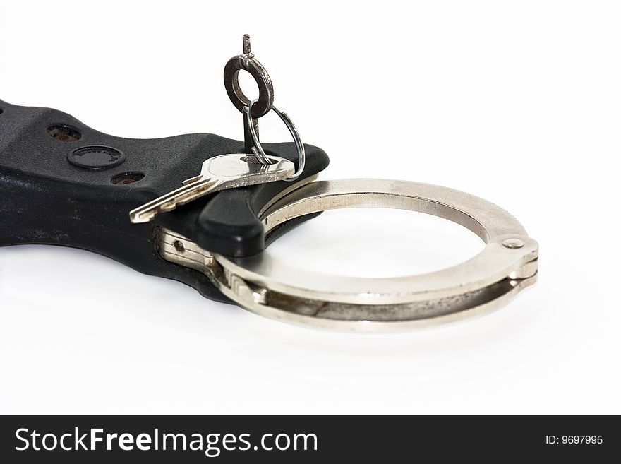 Close up of key in handcuffs isolated on white. Close up of key in handcuffs isolated on white