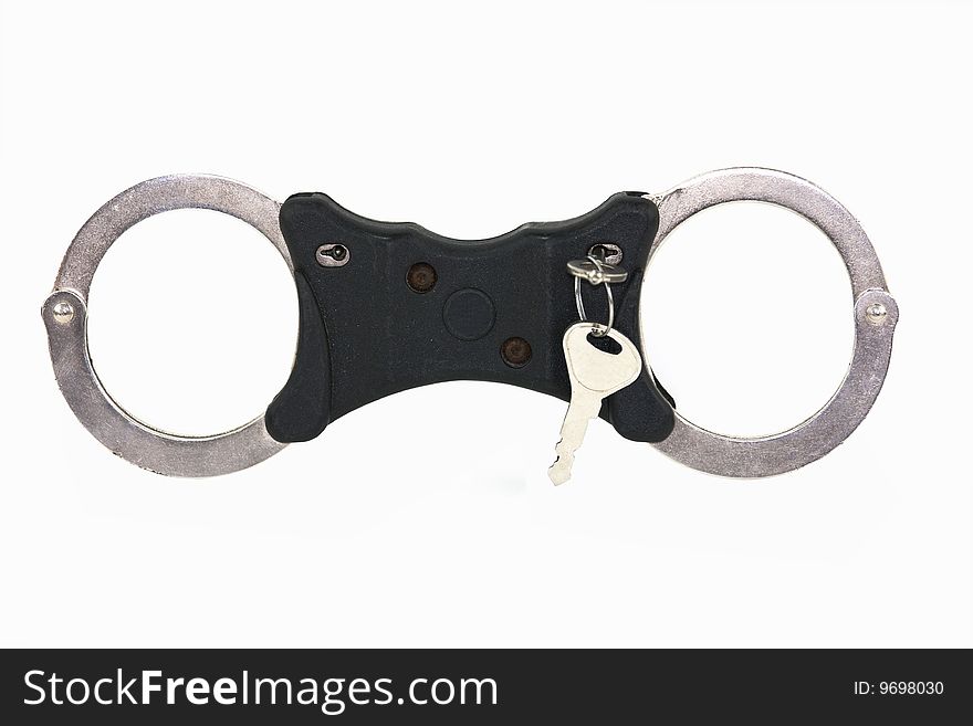 Isolated closed handcuffs on white background with key. Isolated closed handcuffs on white background with key
