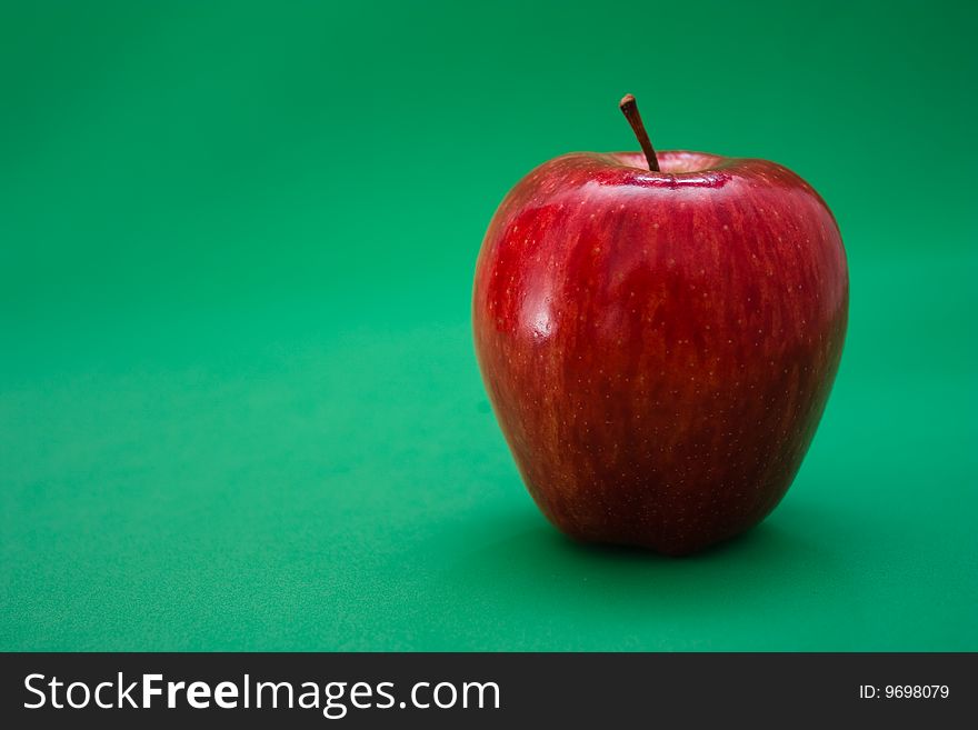 Red apple on a green background