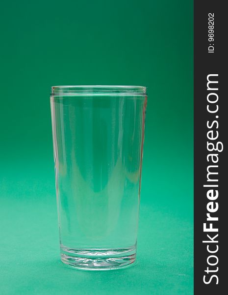 Glass of water on green background. Glass of water on green background
