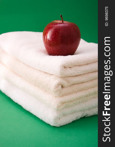 Apple and towels on a green background. Apple and towels on a green background
