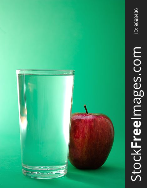 Glass of water and red apple. Glass of water and red apple