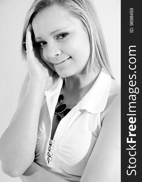 Young female model smiling at the camera edited to black and white for a soft effect. Young female model smiling at the camera edited to black and white for a soft effect.