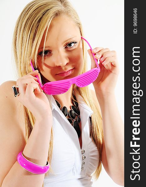 Young female fashion model wearing plastic pink glasses and jewelery
