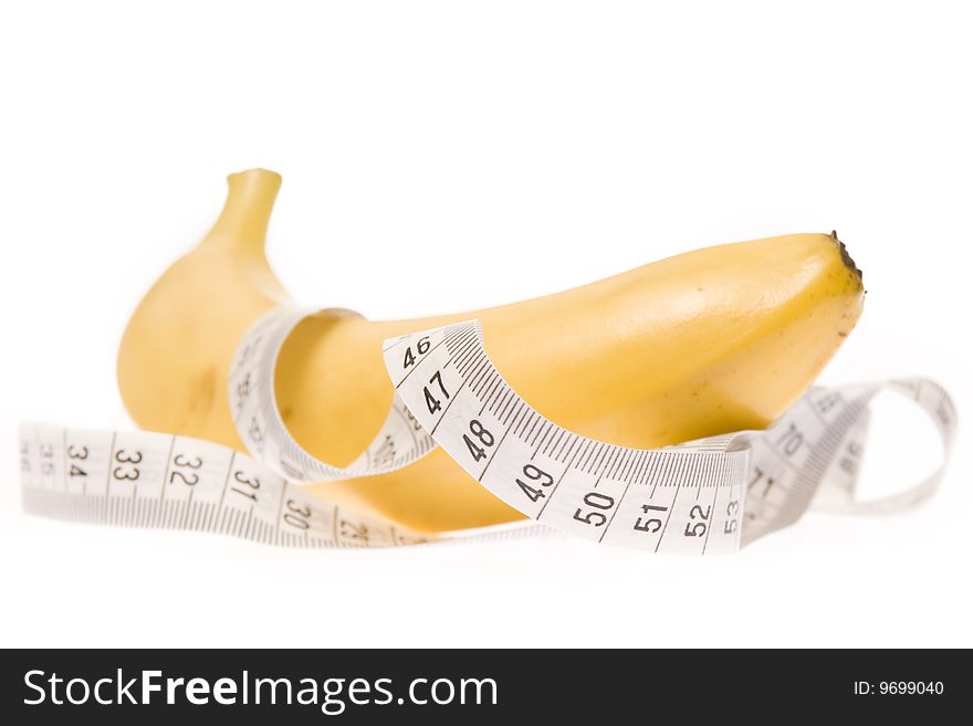 Banana entangled in measuring tape. Banana entangled in measuring tape