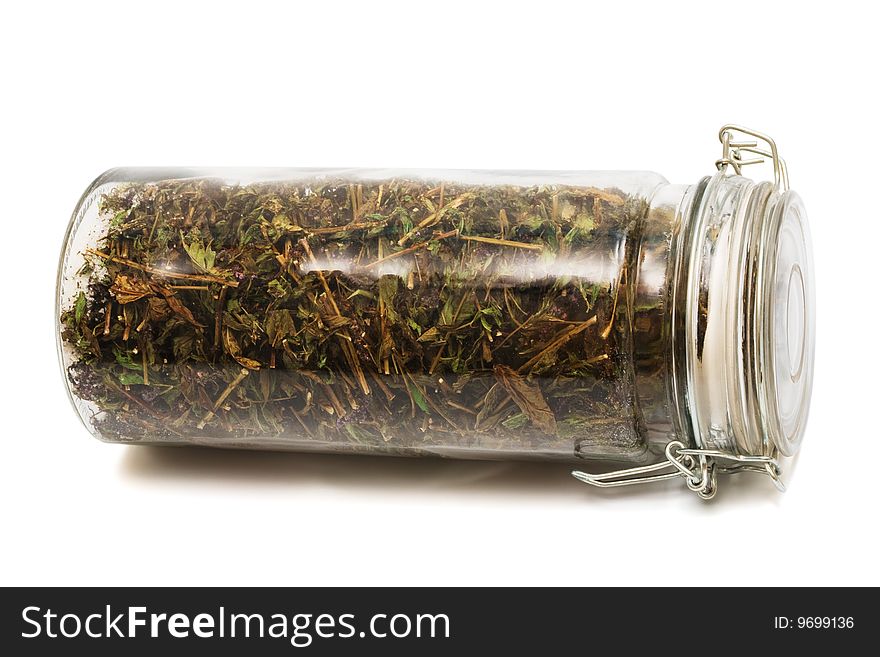 Herbs in a jar on a white background