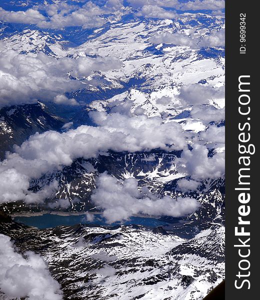 Blue sky with white clouds over lake and mountains,Alps, France. Blue sky with white clouds over lake and mountains,Alps, France.