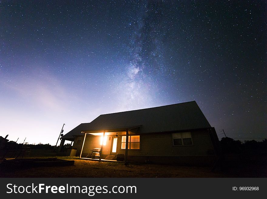 Beige Wooden House Under Starry Night