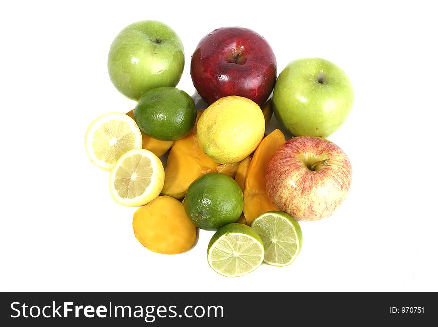 Large selection of colorful fruit including apples, lemons, limes, and cut mango on a white background. Large selection of colorful fruit including apples, lemons, limes, and cut mango on a white background.