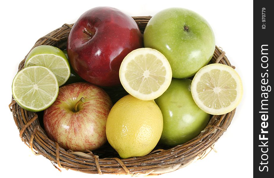 Large selection of colorful fruit including apples, lemons, and limes in a basket isolated on a white background.  Viewed from above. Large selection of colorful fruit including apples, lemons, and limes in a basket isolated on a white background.  Viewed from above.