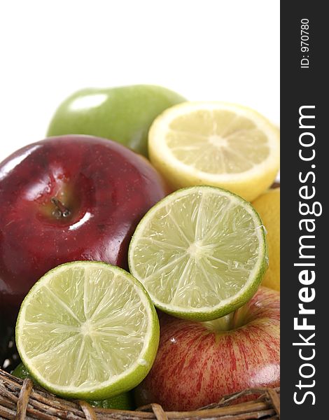 Close-up view of a sliced lime mixed in group with other fruit in a basket. Close-up view of a sliced lime mixed in group with other fruit in a basket.