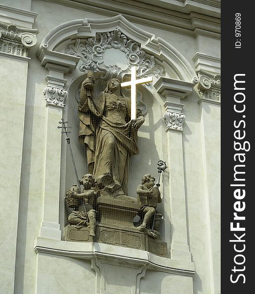 Statue on church in Prague behind net to escape from pigeons