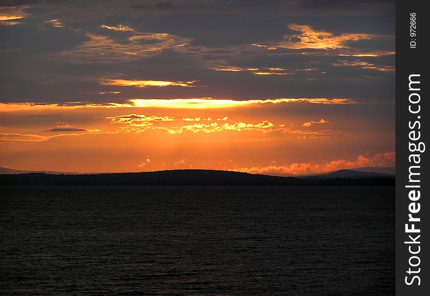 Sunrise over the Green Mountains of Vermont, Viewed from the New York side of Lake Champlain. Sunrise over the Green Mountains of Vermont, Viewed from the New York side of Lake Champlain