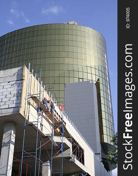 Construction of a building on a background of the blue sky