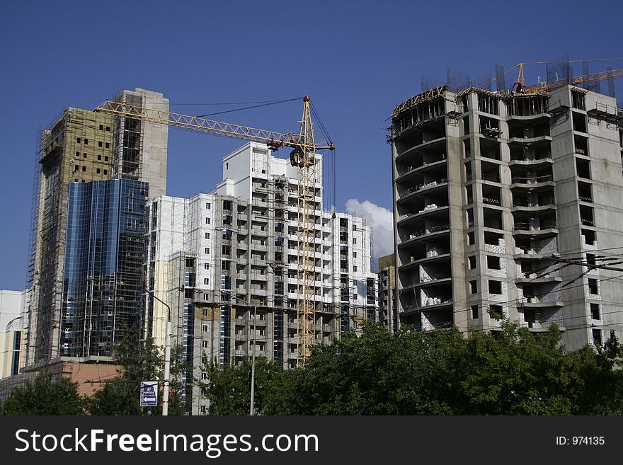 Construction of a building on a background of the blue sky