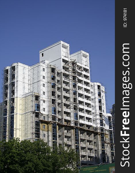 Construction of a building on a background of the blue sky