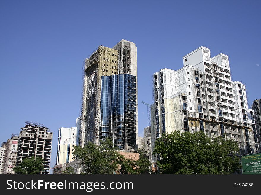 Construction of a building on a background of the blue sky