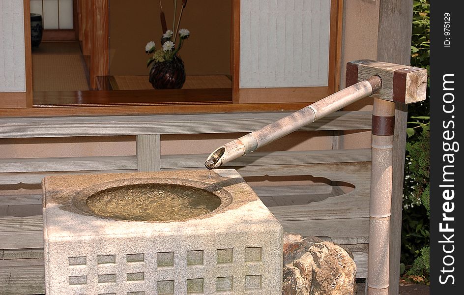 Asian stone and bamboo fountain. Asian stone and bamboo fountain